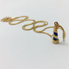 Gold necklace with handcarved blue enamel lighthouse charm