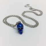 Metallic blue skull pendant